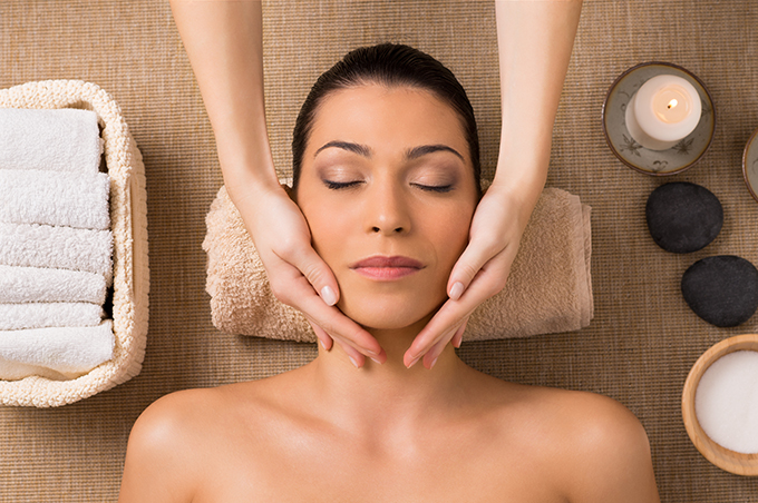 Woman Getting Facial Massage At Spa