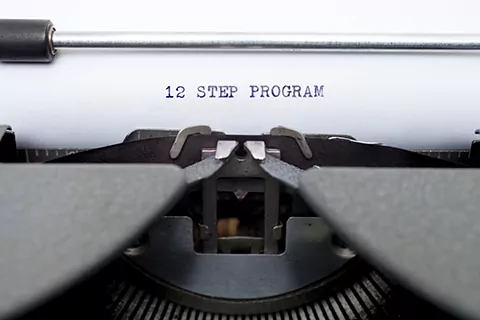 The words 12 Step Program typed on an old typewriter.