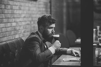 man drinks cognac. Beer time. Man drinking beer in restaurant at meeting or date.