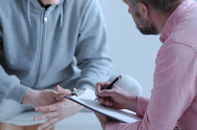 Psychologist interviewing his depressed patient during therapy