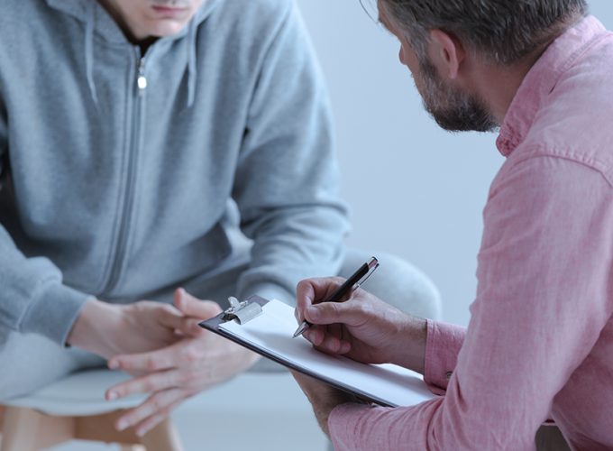 Psychologist interviewing his depressed patient during therapy