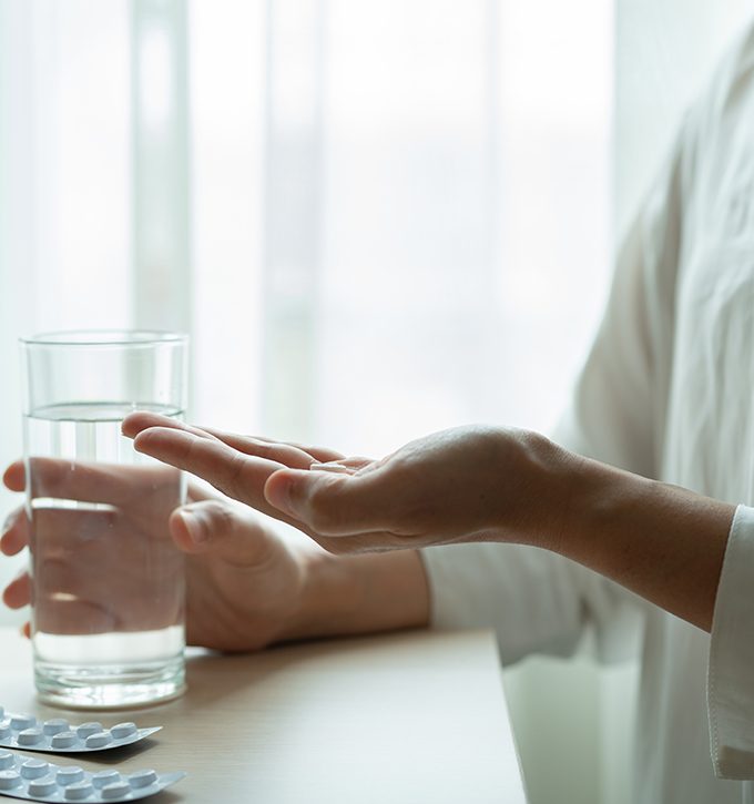 depressed women hand hold medicine with a glass of water, healthcare and medicine recovery concept