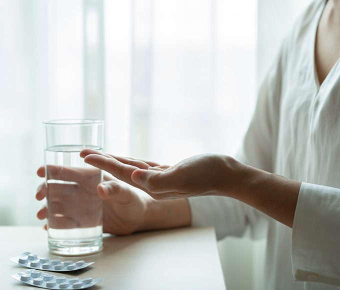 depressed women hand hold medicine with a glass of water, healthcare and medicine recovery concept