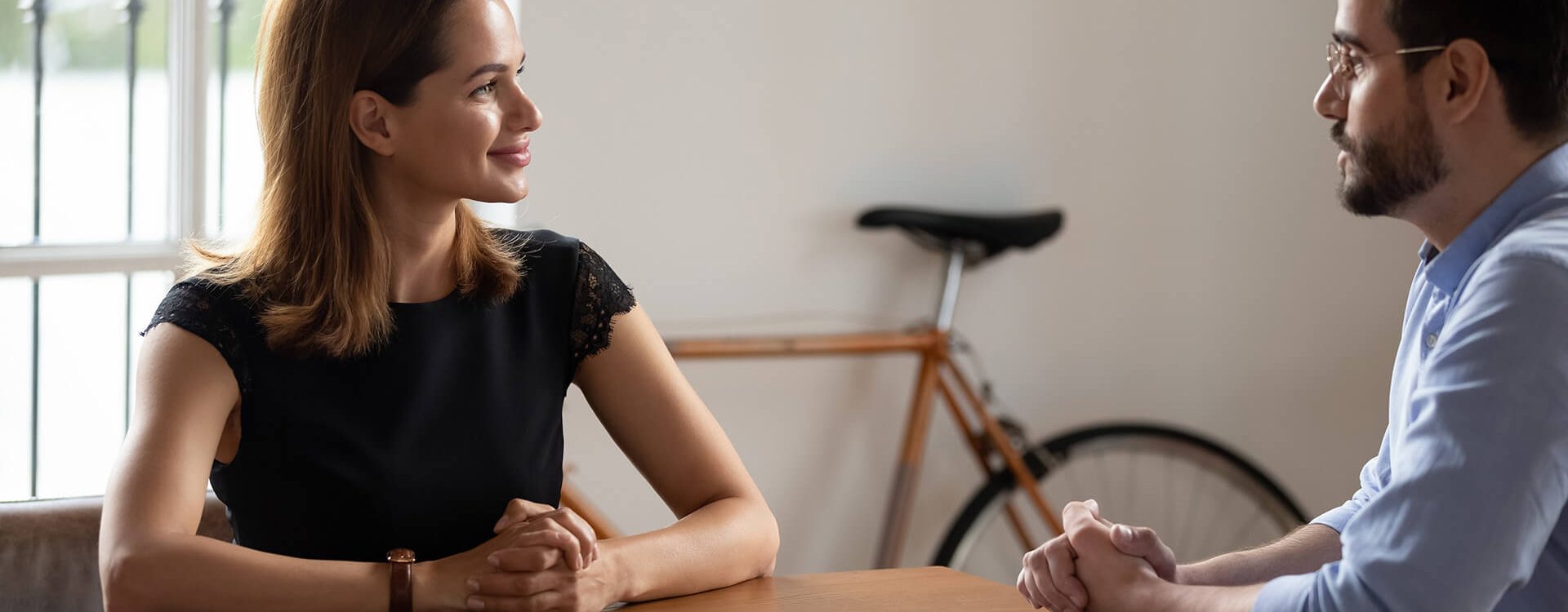 Pleasant young business woman meeting skilled professional lawyer financial advisor at office. Confident female job seeker making good first impression on interview with male hr manager in eyeglasses.