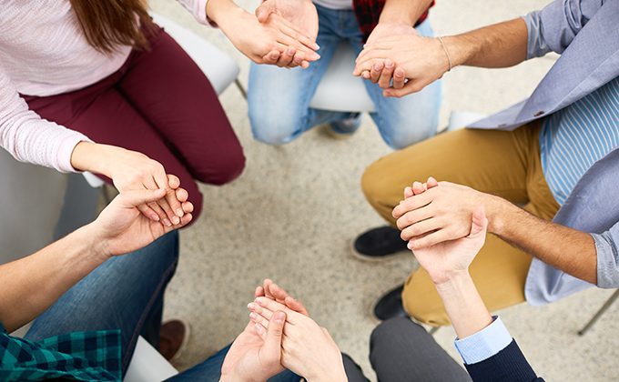 Human hands held together during group psychotherapy
